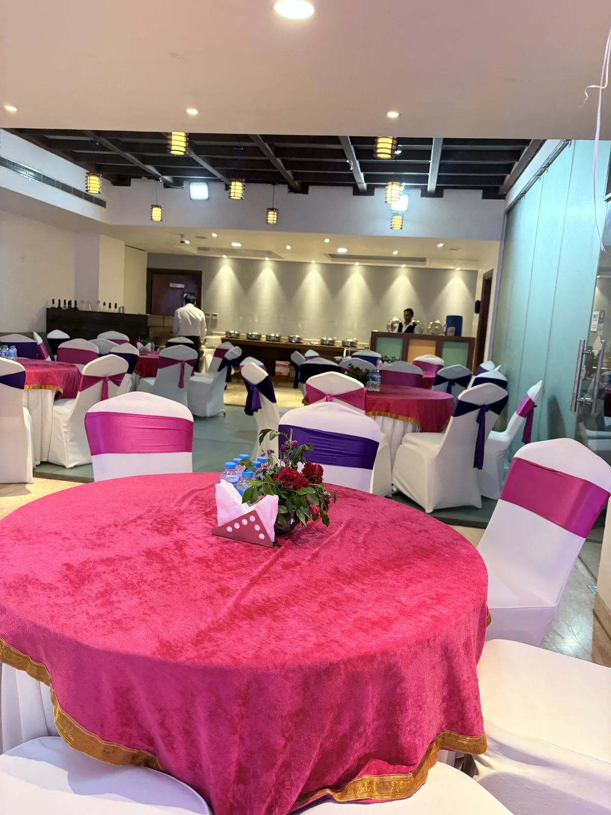 Banquet table with pink linen and sashed chair covers at JK Hotel C R Park