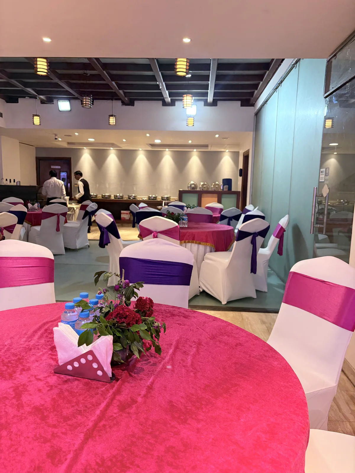 JK Hotel C R Park banquet hall with organised seating rows for a wedding reception