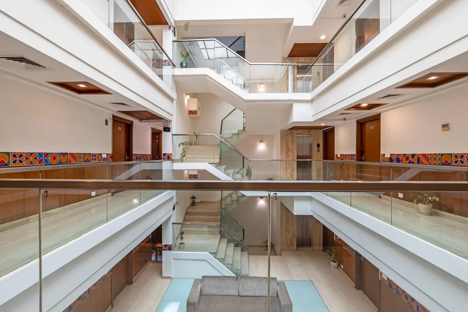 JK Hotel multi-floor open atrium with elegant glass railings JK Hotel multi-floor open atrium with elegant glass railings