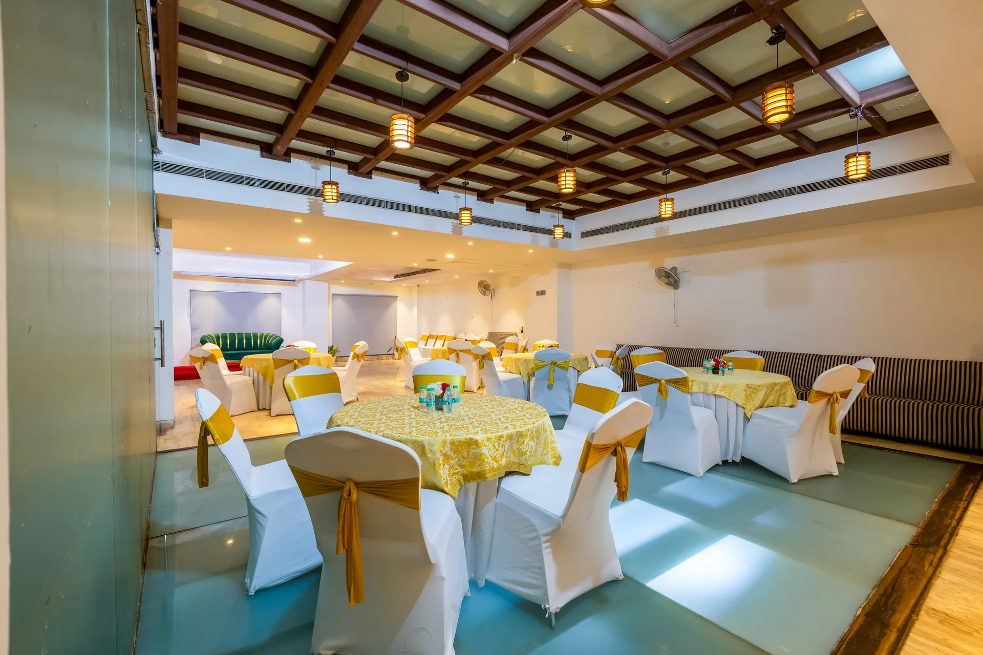 JK Hotel banquet hall with decorated round tables and chairs JK Hotel banquet hall with decorated round tables and chairs