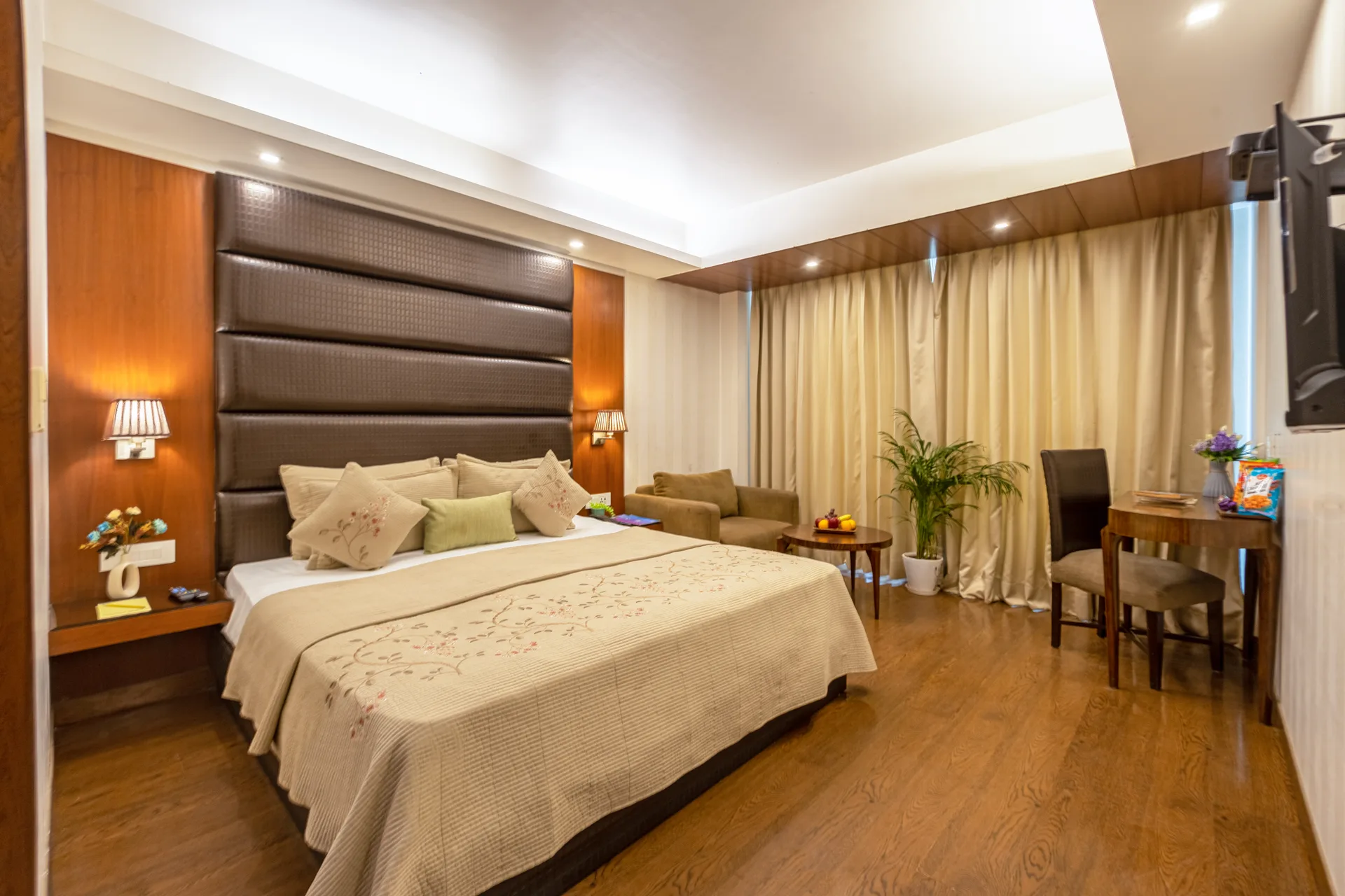 JK Hotel executive suite spacious bedroom with wooden flooring JK Hotel executive suite spacious bedroom with wooden flooring